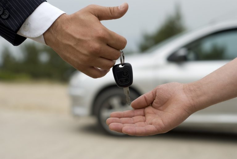 man handing car keys to someone else