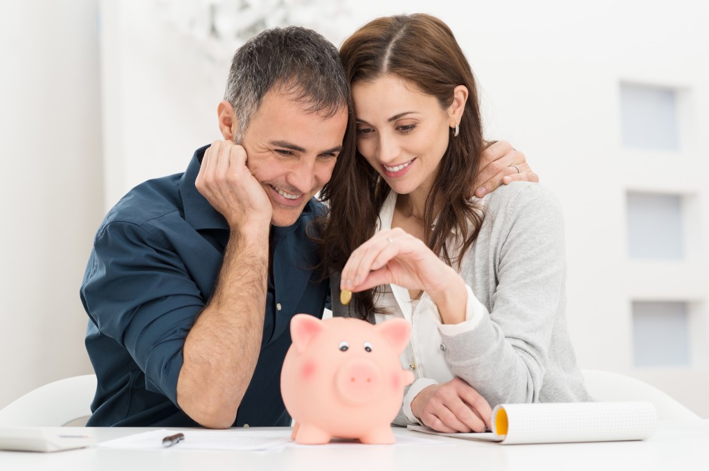 couple looking at piggy bank