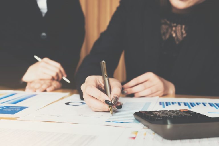 people signing a document