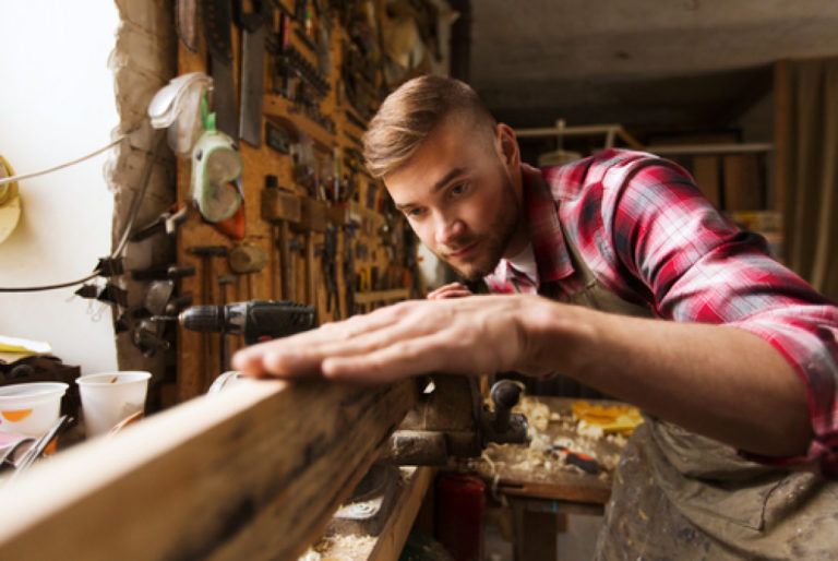 man leveling wood