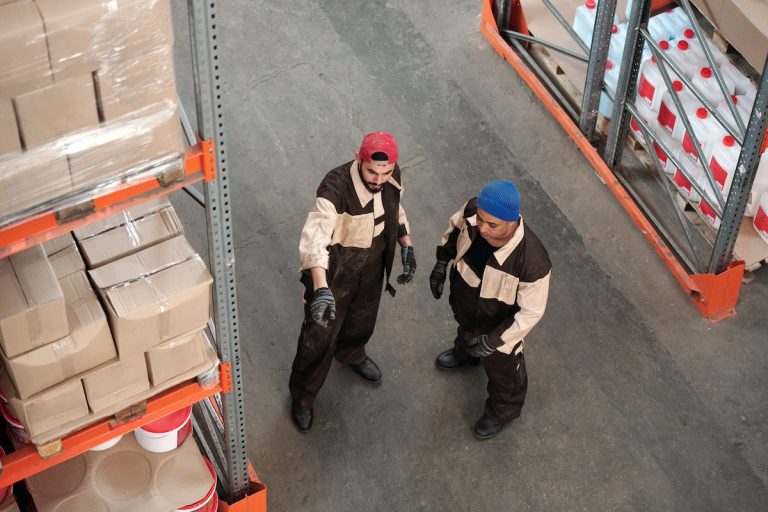 2 Men Standing in a Warehouse Talking