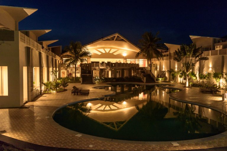 A hotel swimming pool area at night