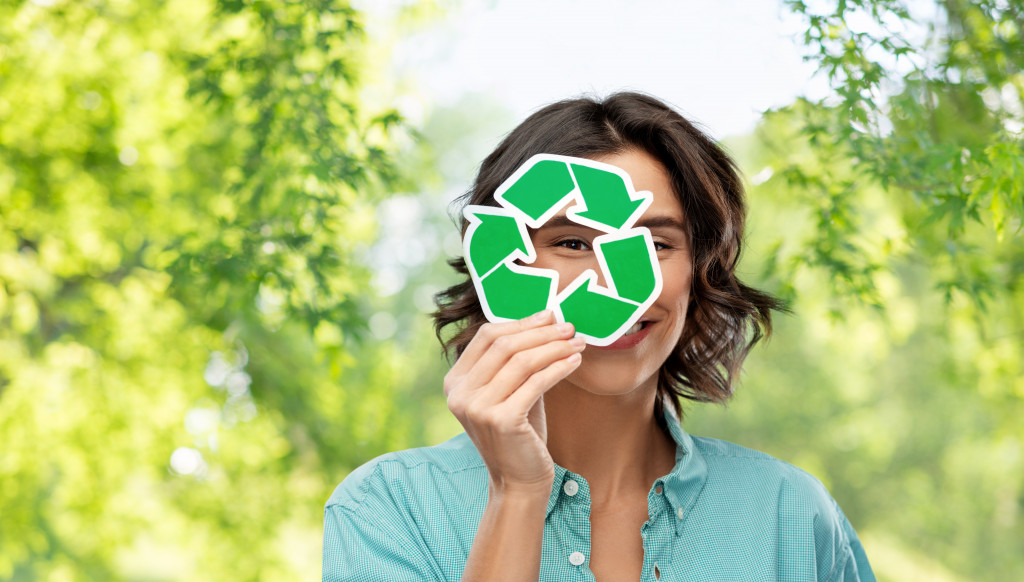 woman holding a recycle icon