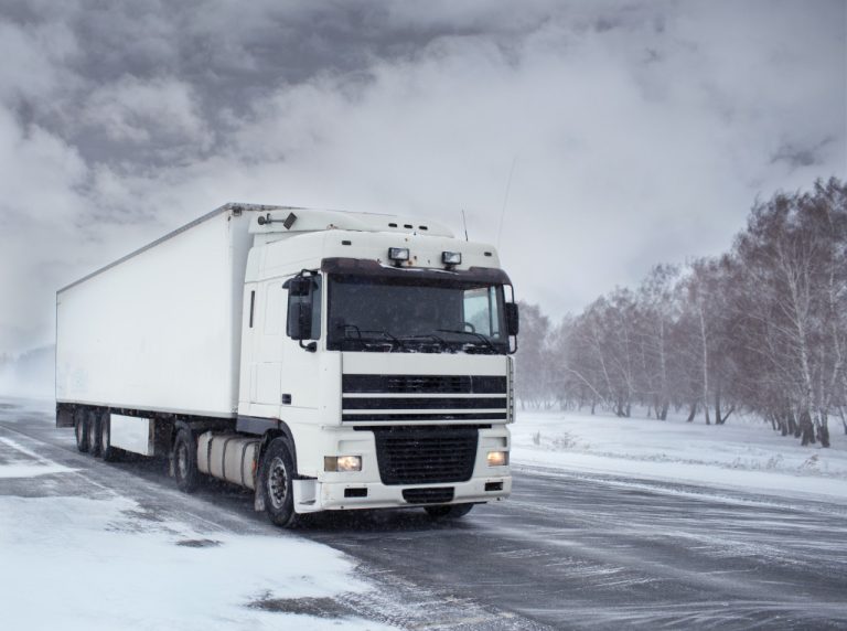 A truck driving through snow